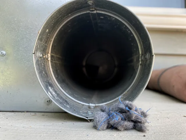 Signal Hill Dryer Vent Cleaning technician using specialized equipment to clear severe dryer vent blockage in Signal Hill